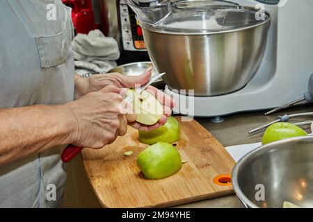 Le chef coupe des pommes pour faire une tarte aux pommes. Recette étape par étape Banque D'Images
