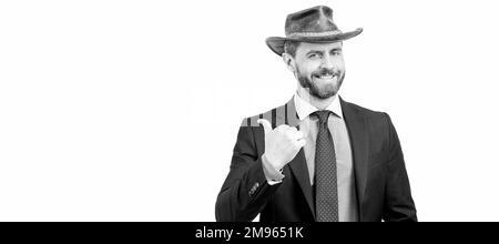 Regardez ceci. Publicité de l'homme de point de doigt de côté. Expert en publicité dans chapeau de cow-boy. Portrait de visage d'homme, bannière avec espace de copie. Homme d'affaires en costume Banque D'Images