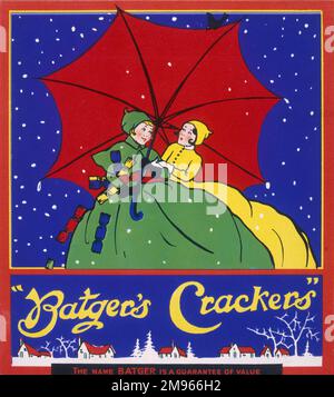 Deux filles en costume vert et jaune avec des jupes volumineuses se protègent ensemble de la neige sous un énorme parapluie. Banque D'Images