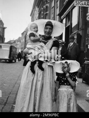 Une femme et deux enfants en robe traditionnelle dans une rue à Middleburg, Hollande. Banque D'Images