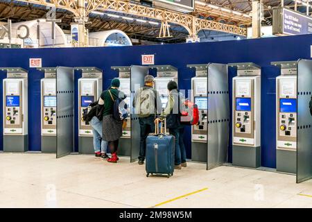 Personnes achetant des billets de train aux machines, Victoria Station, Londres, Royaume-Uni. Banque D'Images