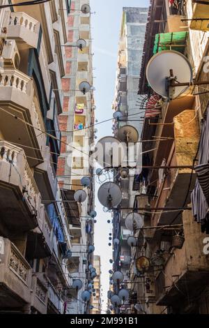 Ruelle étroite avec des plats satellites à Alexandrie, Egypte Banque D'Images