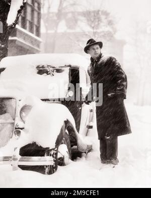 1930S HOMME DEBOUT À CÔTÉ D'UNE VOITURE GARÉE COUVERTE DE NEIGE D'HIVER PROFONDE À LA CHEVILLE - M3479 HAR001 PERSONNES HARS AUTOMOBILE MÂLES RISQUE SUIVANT NEIGE TRANSPORT B&W CONCERNÉ STATIONNEMENT HIVERNAL CONTACT OCULAIRE COUVERT DANGEREUSES CONDITIONS AUTOMOBILES GEL VÉHICULES VERGLAS HIVERNAGE MAUVAIS TEMPS MOYEN-ADULTE MOYEN-ADULTE HOMME NOIR ET BLANC RACE BLANCHE HAR001 OLD FASHIED Banque D'Images