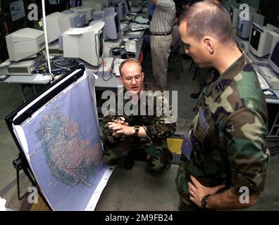 Au cours de l'expérience 2000 des forces expéditionnaires interarmées (JEFX 2000), le capitaine de la grenouille aérienne des États-Unis Robert E. Maxwell (à droite), le 32nd Escadron du renseignement aérien Ramstein, en Allemagne, et le CPT Rex Miller (à gauche), USAF, 497th Groupe des opérations d'information/ Division du ciblage, base aérienne de Bolling, Washington, D.C. choisissent des cibles pour un ordre d'attribution de mission aérienne, Aire d'entraînement permanente, Hurlburt Field, Floride. Le JEFX 2000 fera la démonstration de la capacité de l'USAF à déployer et à employer une puissance aérospatiale décisive au commandant de la force conjointe. Le domaine principal sera le soutien au combat Agile, la mobilité mondiale et Banque D'Images