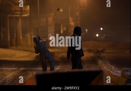 Naplouse. 18th janvier 2023. Un manifestant palestinien lance une pierre aux forces israéliennes lors d'affrontements dans la ville de Naplouse, en Cisjordanie, le 18 janvier 2023. Credit: Ayman Nobani/Xinhua/Alamy Live News Banque D'Images