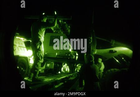 Photographie légère montrant des avions de l'US Air Force (USAF) affectés au groupe des opérations de mobilité aérienne (AMOG) 615th, effectuant des opérations de chargement de nuit dans un lieu de déploiement vers l'avant près de Kirkouk, en Irak, pendant l'opération LIBERTÉ IRAQUIENNE. Objet opération/série: BASE DE LIBERTÉ IRAQUIENNE: Kirkuk pays: Irak (IRQ) Banque D'Images