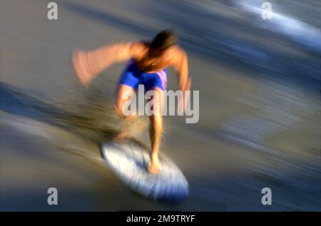 Mouvement flou panoramique d'un boarder skim à la plage dans le sud de la Californie Banque D'Images