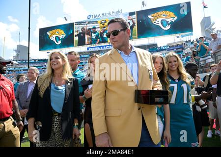 Former Jacksonville Jaguars offensive tackle Tony Boselli, right, stands  with owner Shahid Khan, center, as Pro Football Hall of Fame president Jim  Porter speaks during a ceremony where Boselli was presented with