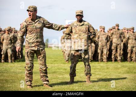 Le commandant Mario Terenas de la Division des montagnes de 10th exprime l'approbation enthousiaste du Pvt Thornhill, un soldat avec un DIV de 10th MTN et récipiendaire de l'insigne d'expert Infantryman, lors d'une cérémonie de remise de prix à Sexton Field, à fort Drum, N.Y., 26 mai 2022. Banque D'Images