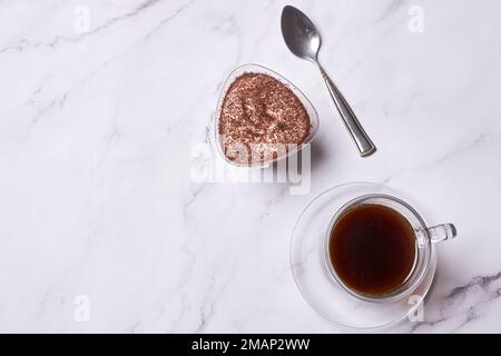 deux tasses de café, l'une avec du chocolat et l'autre avec du sucre brun sur une surface en marbre blanc Banque D'Images