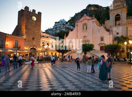 Tour de l'horloge Torre dell'Orologio, église Chiesa di San Giuseppe, les personnes se promenant sur la Piazza IX Aprile, Corso Umberto, Dusk, Taormina, Sicile, Italie Banque D'Images