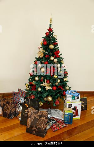 Minas Gerais, Brésil - 23 décembre 2022 : arbre de noël avec détails festifs et divers cadeaux emballés Banque D'Images