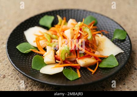 Salade avec poires, carottes, céleri, poivron et Purslane d'hiver. Banque D'Images