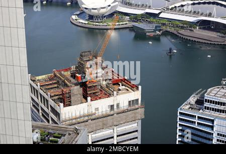 Photo à grand angle de la grue jaune sur le dessus du bâtiment, utilisée sur le chantier de construction. Banque D'Images