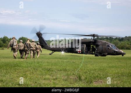 Des soldats affectés à 510th Compagnie des ressources humaines, 10th Bataillon des troupes de soutien de la Division, 10th Brigade de soutien de la Division des montagnes, marchent vers un aéronef, 15 juin 2022, pendant l’entraînement d’évacuation médicale des RH de 510th à fort Drum, New York. Banque D'Images