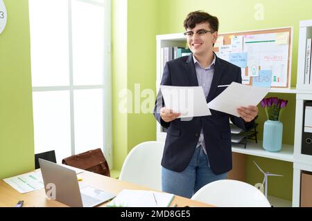 Un travailleur d'affaires non binaire lisant le document au bureau Banque D'Images