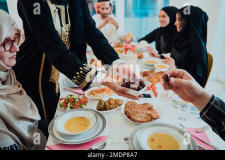 Famille musulmane ayant Iftar dîner eau potable pour briser la fête. Manger de la nourriture traditionnelle pendant le mois de la fête du Ramadan à la maison. Le halal islamique Banque D'Images