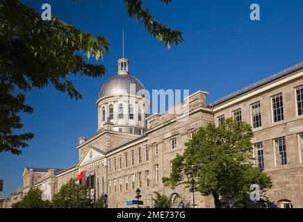 Construction du marché Bonsecours à travers des arbres à feuilles caduques au printemps, Vieux-Montréal, Québec, Canada. Banque D'Images