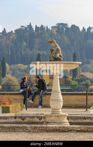 Couple assis près d'une fontaine dans les jardins de Boboli à Florence, Italie Banque D'Images