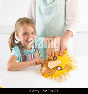 Fille faisant le masque de lion, 5 ans Banque D'Images