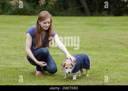 Adolescente avec un vieux Jack russell dans le jardin Banque D'Images