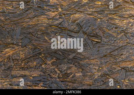 Texture du panneau OSB. Arrière-plan en bois marron. Motif simple en tableau de bord pressé. Texture bois brun. Arrière-plan de la carte à puce. Banque D'Images