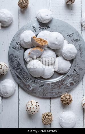 Petits gâteaux au pain d'épice sur une assiette argentée pour noël ou la saison de l'Avent frais et faits maison cuits avec du glaçage blanc d'oeuf Banque D'Images