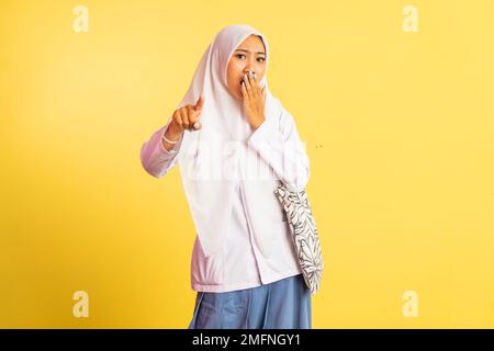 choqué fille voilée dans l'uniforme de l'école secondaire avec le doigt pointant Banque D'Images