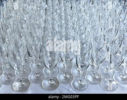 Des rangées de flûtes à champagne vides sur une table lors d'un événement en attente de remplissage. Personne. Banque D'Images