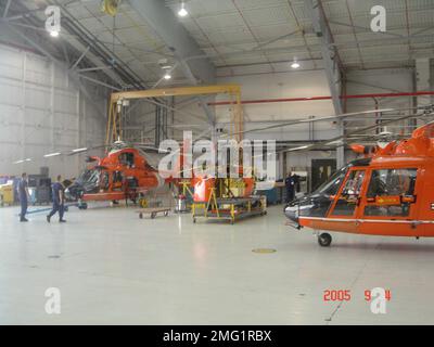 Avions - HH-65 Dolphin - 26-HK-54-53. HH-65s et le personnel dans le hangar. Ouragan Katrina Banque D'Images