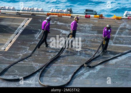 Mer de Chine méridionale. 20th janvier 2023. ÉTATS-UNIS Les marins de la Marine transportent un tuyau de carburant à jet hors du pont de vol du porte-avions USS Nimitz (CVN 68). Nimitz est aux États-Unis 7th Fleet qui effectue des opérations de routine. 7th Fleet est le U.S. La plus grande flotte numérotée déployée à l'avance de la Marine interagit et opère régulièrement avec ses alliés et partenaires pour préserver une région libre et ouverte de l'Indo-Pacifique. (Photo de Samuel Osborn) (Credit image: © U.S. Navy/ZUMA Press Wire Service) USAGE ÉDITORIAL UNIQUEMENT ! Non destiné À un usage commercial ! Banque D'Images