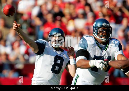 San Francisco 49ers safety Talanoa Hufanga, left, poses for photos with  former 49ers player Jesse Sapolu, middle, while exchanging jerseys with  Miami Dolphins quarterback Tua Tagovailoa, right, after an NFL football game