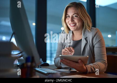 J'ai utilisé ces nuits tardives. Portrait rogné d'une femme d'affaires travaillant sur une tablette numérique dans son bureau tard dans la nuit. Banque D'Images