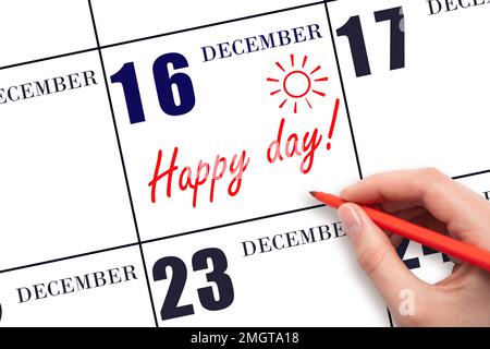 16th jour de décembre. Écrire le texte HAPPY DAY à la main et dessiner le soleil sur la date du calendrier 16 décembre. Enregistrez la date. Vacances. Motivation. Hiver Banque D'Images