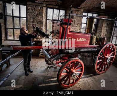 Le conservateur John McGoldrick nettoie un moteur d'incendie de 130 ans au musée industriel de Leeds, dans l'exposition Power House, qui explore l'évolution des moteurs à travers les âges. Autrefois un pilier du service d'incendie, l'impressionnant moteur d'époque a été fabriqué en 1891 par le célèbre Shand Mason and Co Avec une chaudière fabriquée à partir de fer du Yorkshire, le moteur a été entraîné par des chevaux, avec la capacité de lever de la vapeur sur son chemin vers un feu. Date de la photo: Jeudi 26 janvier 2023. Banque D'Images