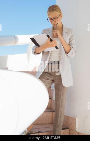 Jeune femme d'affaires blonde pensant à de nouvelles idées de projet. Banque D'Images