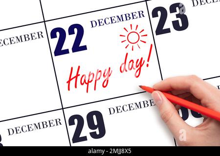 22nd jour de décembre. Écrire le texte HAPPY DAY à la main et dessiner le soleil sur la date du calendrier 22 décembre. Enregistrez la date. Vacances. Motivation. Hiver Banque D'Images