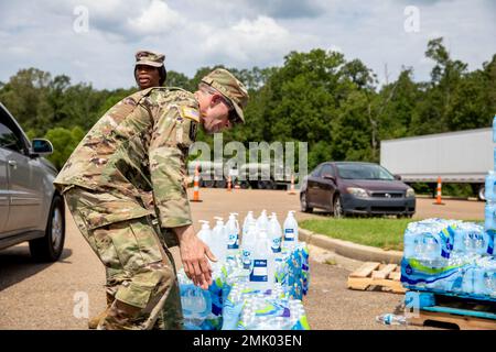 Les soldats du 1st Bataillon, 185th Aviation Regiment, 66th troupe Command, Mississippi Army National Guard, distribuent de l'eau à l'école moyenne Thomas Cardozo à Jackson, Mississippi, le 2 septembre 2022. Près de 600 gardes nationaux du Mississippi ont été établis sur sept sites à travers Jackson pour permettre aux gens de recueillir de l'eau en bouteille, de l'assainisseur pour les mains et de l'eau non potable dans des camions de buffles d'eau. Banque D'Images