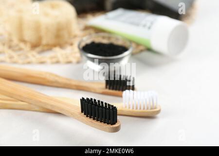 Brosses à dents en bambou sur table blanche, gros plan. Espace pour le texte Banque D'Images