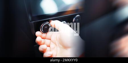 Le processus de choix de la climatisation dans la voiture. Homme réglant la température de l'air conditionné de la voiture. Intérieur de voiture moderne Banque D'Images