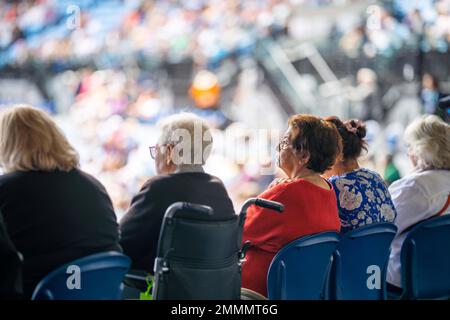 fan de tennis âgé regardant un match de tennis en fauteuil roulant à l'open australien en été Banque D'Images