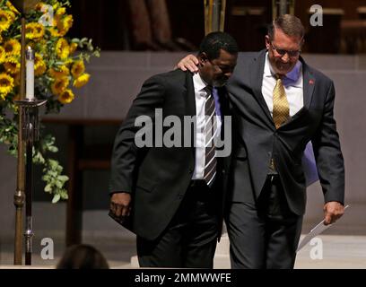 San Francisco 49ers safety Talanoa Hufanga, left, poses for photos with  former 49ers player Jesse Sapolu, middle, while exchanging jerseys with  Miami Dolphins quarterback Tua Tagovailoa, right, after an NFL football game