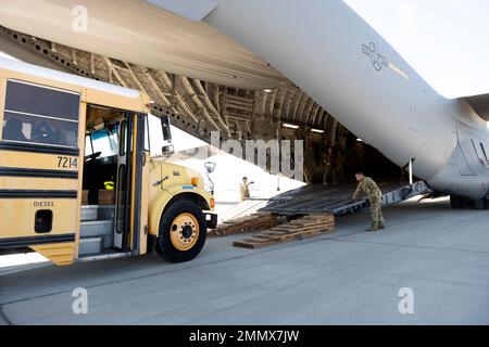 Un autobus scolaire s'approche d'un C-17 Globemaster III le 23 septembre 2022, à la base de réserve aérienne de mars, en Californie. Un équipage de réserve du 301st e Escadron de transport aérien a effectué une mission de trois jours du 23 au 25 septembre pour transporter du fret humanitaire en Haïti. Grâce au programme Denton, trois autobus scolaires donnés du district scolaire unifié de San Diego ont été transportés de l'ARB de mars à Haïti. Banque D'Images