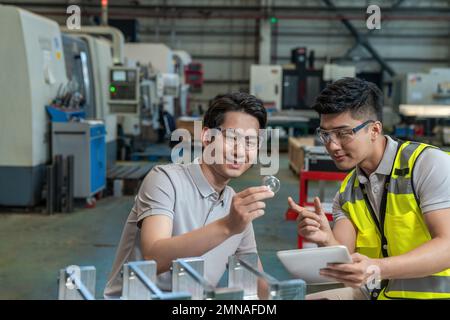 Deux ingénieurs à l'usine pour effectuer des mesures Banque D'Images