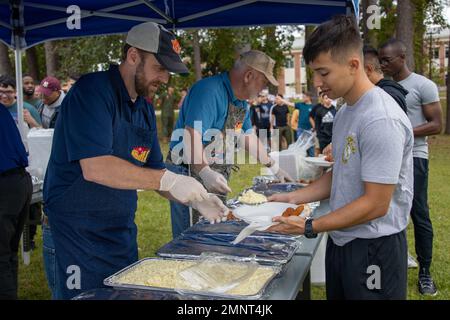 Un bénévole de l’Alliance militaire de la Chambre de commerce de New Bern sert de la nourriture à un Marine américain à l’automne 2022 Chicken Pickin’ on Marine corps Air Station Cherry point, Caroline du Nord, Oct. 5, 2022. L'événement a permis aux membres du service de se rassembler et de profiter de la nourriture et de la musique gratuites. La New Bern Chamber of commerce Military Alliance a préparé et servi plus de 100 poulets aux militaires et à leurs familles. Poulet Pickin’, MCAS Cherry point, Marine corps, Marines, New Bern Chamber of commerce Military Alliance, Fun, Banque D'Images