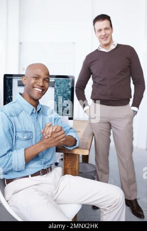 Les travailleurs heureux sont les plus productifs. Portrait de deux hommes d'affaires au bureau. Banque D'Images