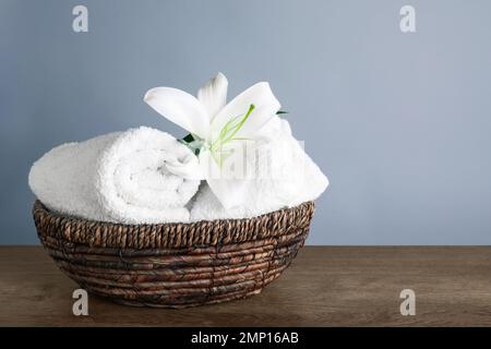 Serviettes fraîches et fleur de nénuphars sur une table en bois, espace pour le texte Banque D'Images