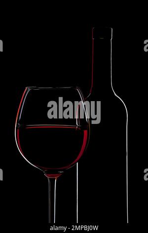 Silhouette de bouteille de vin rouge et verre de vin sur fond noir Banque D'Images