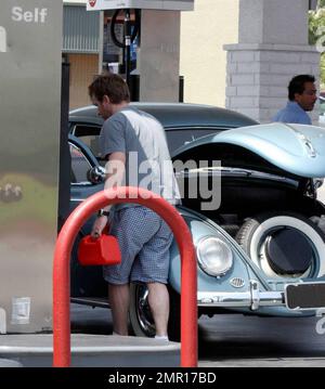 Exclusif !! Ewan McGregor s'arrête à une station-service dans un classique Volkswagen Beetle. Il remplit la voiture et deux petits conteneurs de gaz portables. Il est entré dans le compartiment avant pour remplir la voiture de gaz. LA, CA, 05/15/09. Banque D'Images