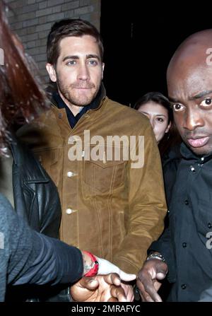 Guidé par des gardes du corps, l'acteur Jake Gyllenhaal arrive à l'Apple Store de Soho à une foule de fans. Gyllenhaal a fait l'apparition dans le magasin pour promouvoir son nouveau thriller « Source Code », qui a été publié aujourd'hui. New York, NY. 4/1/11. Banque D'Images